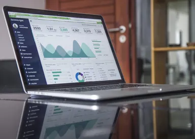 laptop with an analytical dashboard displayed